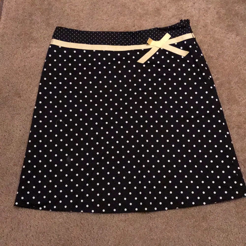 Black skirt with white polka dots and yellow bow